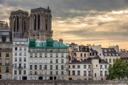 Paris, France - May 7, 2020: Haussmann buildings along the Seine river and Notre Dame cathedral Towers in backgroundのeditorial素材