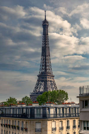 Paris, France - May 13, 2020: Haussmann buildings with trees on rooftop and Eiffel tower in backgroundのeditorial素材