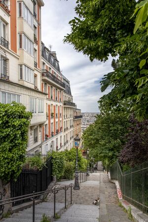 Paris, France - May 12, 2020: Typical stairs and Haussmann buildings in Montmartre in Parisの写真素材