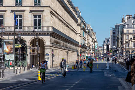 Paris, France - May 29, 2020: Cyclists drives on empty street (Rue de Rivoli) after the...