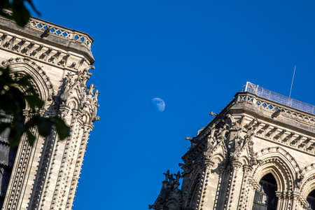 Paris, France - June 1, 2020: Beautiful view of the Notre-Dame Cathedral with a faint moon above it in Parisのeditorial素材