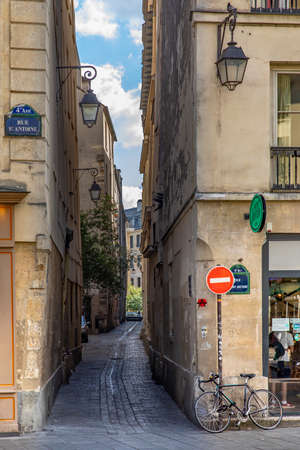 Paris, France - May 25, 2020: Small street with old street lamp near rue St Antoine in Parisのeditorial素材