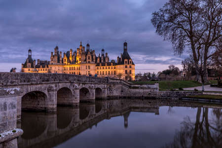 Chambord, France - December 26, 2020: Chambord castle with christmas trees and lights at blue hourのeditorial素材