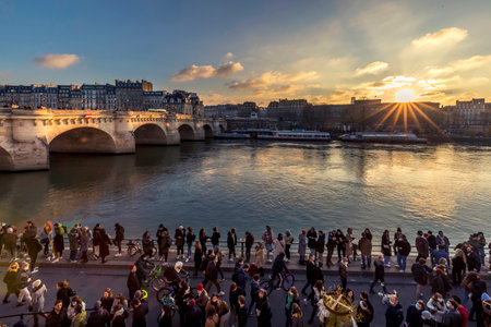 Paris, France - January 9, 2021: Many people take a drink on the banks of the Seine river despite the covid19 near the Pont Neuf in Parisのeditorial素材