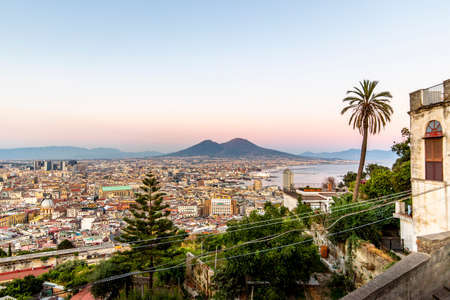 Napoli, Italy - July 11, 2021: Bay of Napoli and Vesuvius volcano in background at sunset in a summer day in Italy, Campaniaのeditorial素材