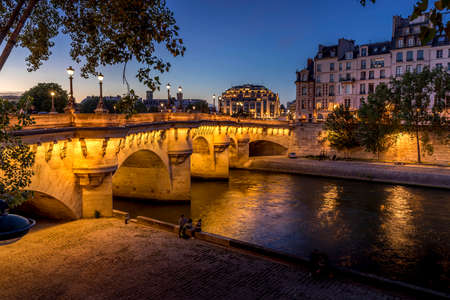 Paris, France - July 8, 2021: Pont Neuf bridge and Cite island over Seine river at night in Parisのeditorial素材