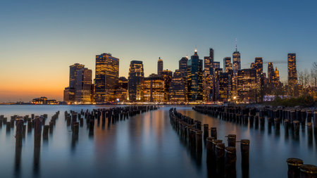 New York, USA - April 25, 2022: Long exposure of the Lower Manhattan skyline at sunset with an old...