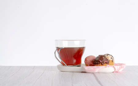 cupcakes of different flavors and colors accompanied by a cup of tea