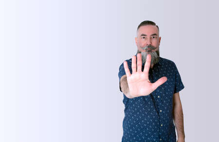 bearded hipster 40-45 years old, reaching out and putting his hand in front of him as a sign of...