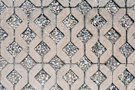 background or texture of cement and repetitive rhomboid-shaped pebbles