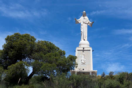 Side view of the grandiose construction of the sculpture of the Sacred Heart of Jesus located on the balcony of the municipality of Totana, Murcia, Spain.のeditorial素材