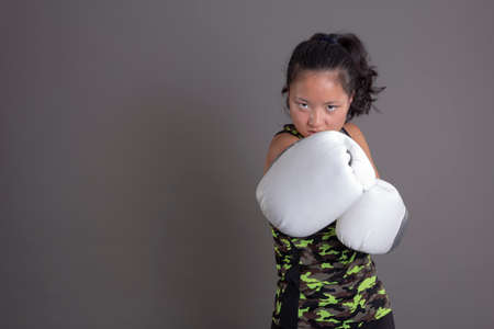 asian ethnicity sportswoman with boxing glovesの写真素材