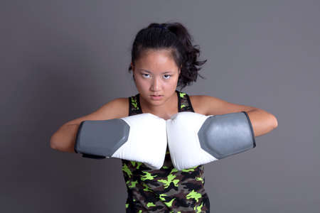 asian ethnicity sportswoman with boxing gloves