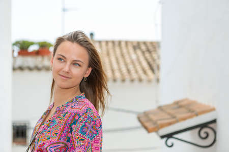 young blonde in an alley in mediterranean villageの写真素材