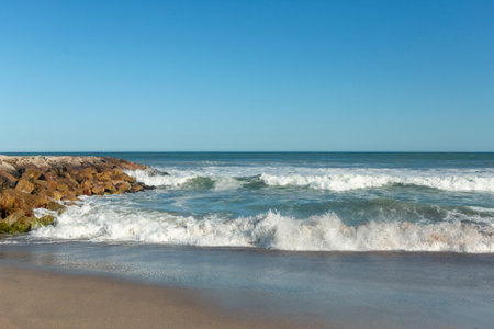 rock breakwater on mar del plata beach, Argentinaの写真素材
