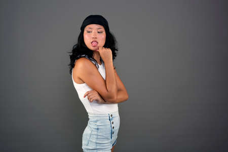 young ethnic asian woman in urban attire defiant attitudeの写真素材