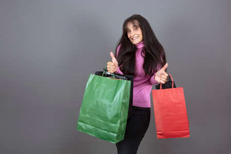woman in her 40s with shopping bags isolated from the backgroundの写真素材