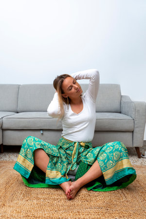 young blonde woman practicing yoga at homeの写真素材