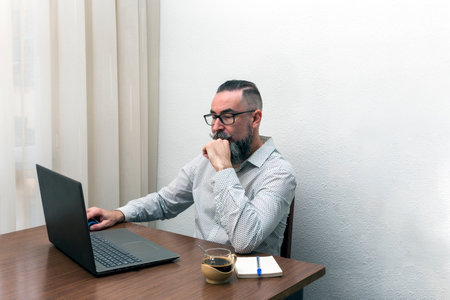 hipster bearded man working with laptop computer at homeの写真素材