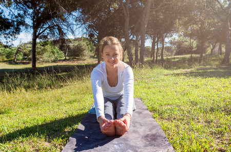 young woman stretching in the forestの写真素材