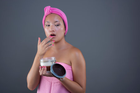 beautiful asian ethnicity woman cleaning her faceの写真素材