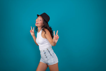Asian woman sticking out her tongue. and making the victory signの写真素材