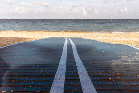 Step by Step: Walking Towards the Shore on the Beachの写真素材