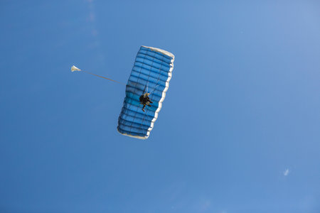 two-person parachute descent seen from belowの写真素材