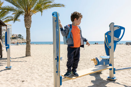 child playing in playground facilities located at the beachの写真素材