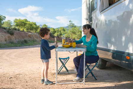 son and mother camper with motor homeの写真素材