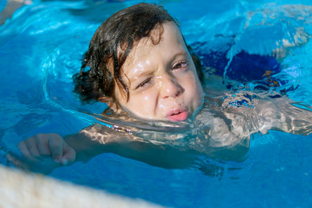 Child enjoying the swimming poolの写真素材