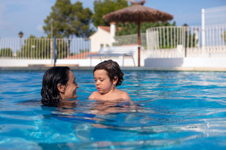 happy mother and kid enjoying vacation in swimming poolの写真素材