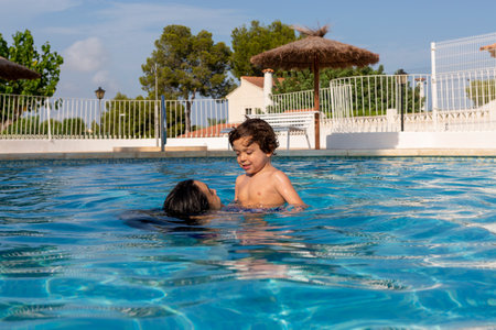 happy mother and kid enjoying vacation in swimming poolの写真素材