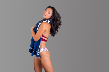 beauty asian ethnic woman in bikini with towel around her neckの写真素材
