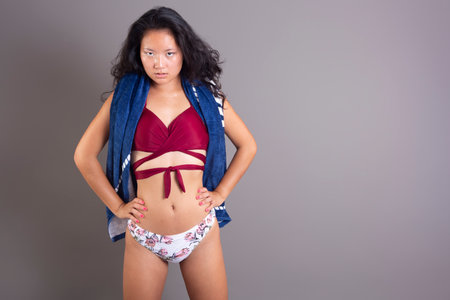 beauty asian ethnic woman in bikini with towel around her neckの写真素材