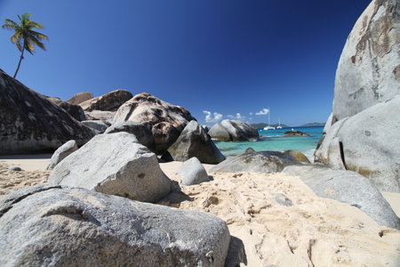 Paradise and lonely beach with large rocks and fine sandの写真素材
