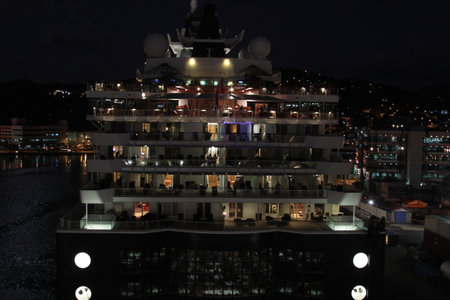 Stern of cruise ship docked in port at nightの写真素材