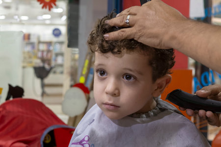 Caucasian boy getting hairstyle in barbershop.の写真素材