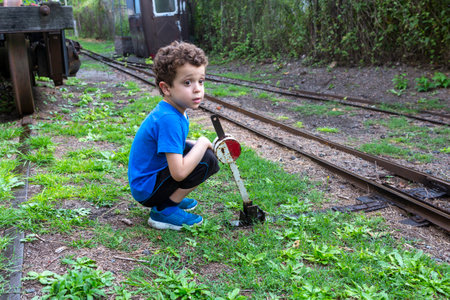 child on railroad track switch leverの写真素材