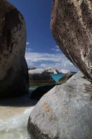 Paradise and lonely beach with large rocks and fine sandの写真素材
