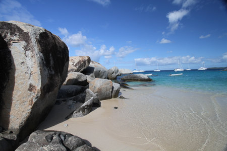 Paradise and lonely beach with large rocks and fine sandの写真素材