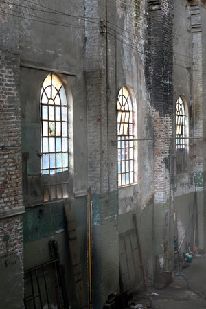old and dirty glass window in factory or warehouse seen from insideの写真素材