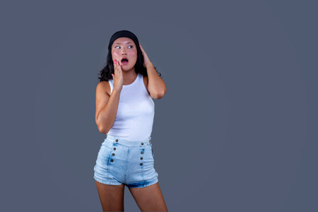 chinese woman with bandana isolated from the background and funny expressionの写真素材