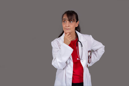 female doctor with thoughtful expression isolated from the backgroundの写真素材