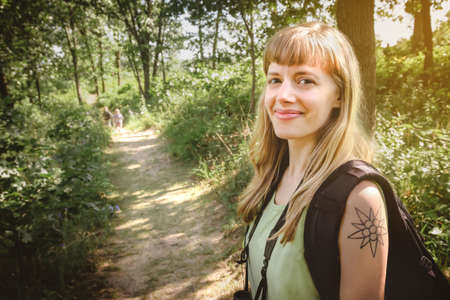 Woman hiking through the forest along a dune trail at Indiana Dunes State Park.
