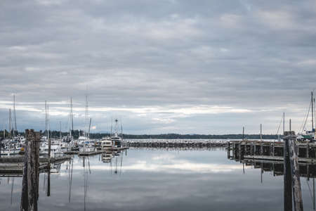 Clouds reflecting on the water at Blaine Harbor in Blaine, Washington.の写真素材