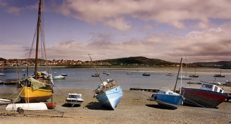  A Beautiful Late Afternoon Scene of Boats Moored In Wales With Moody Sky の写真素材