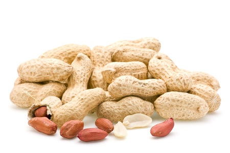Peanuts in shells focus on front exposed peanuts.