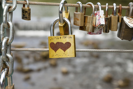 Bakewell, Derbyshire, England, UK - July 19, 2015: Love locks attached to the cable on weir bridge, Bakewell, Derbyshire, England, UK,のeditorial素材