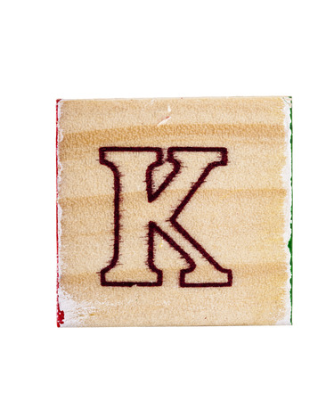 Wooden alphabet letter K block isolated on whiteの写真素材